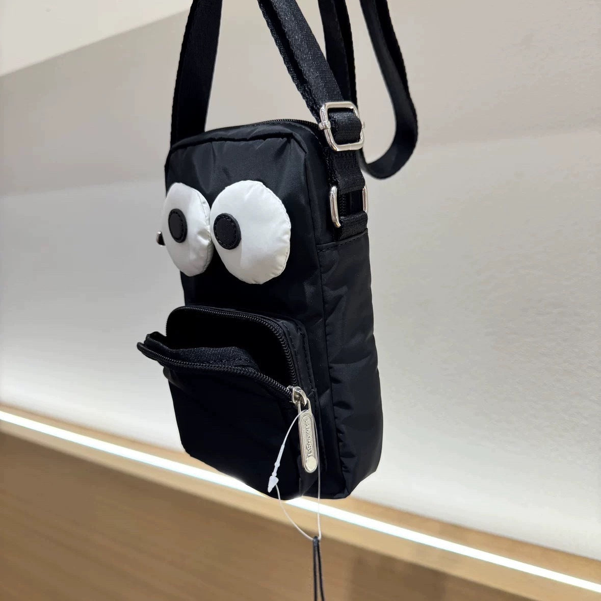 Cartoon NEWNEW series versatile lightweight black eye bag mobile phone bag messenger bag L133