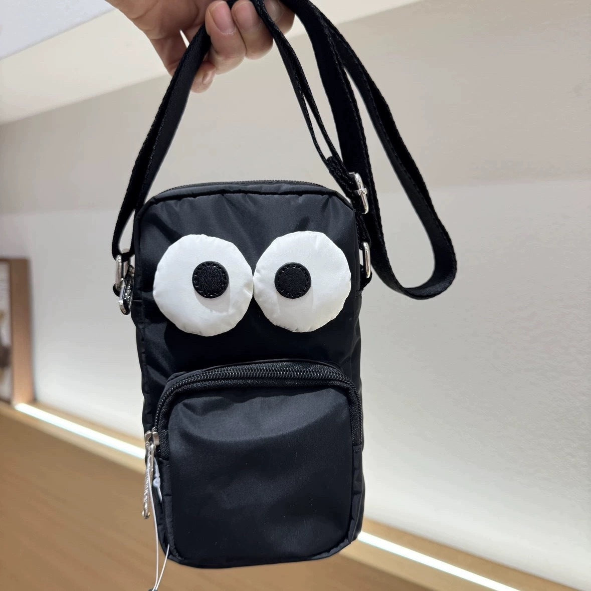 Cartoon NEWNEW series versatile lightweight black eye bag mobile phone bag messenger bag L133